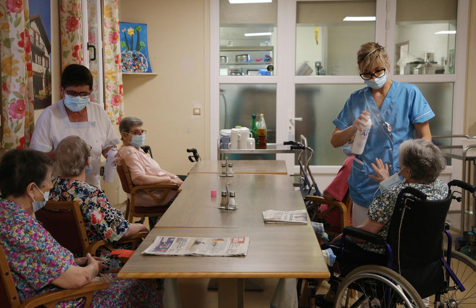 FILE - Health workers refresh residents of a retirement home in Isturitz, southwestern France, Wednesday, June 15, 2022. The U.N. labor organization warned Monday, April 22, 2024, that over 70% of the world's workforce is likely to be exposed to excessive heat during their careers, citing increased concern about exposure to sunlight. It also warned of air pollution, pesticides and other hazards that could lead to health problems, including cancer. (AP Photo/Bob Edme, File)