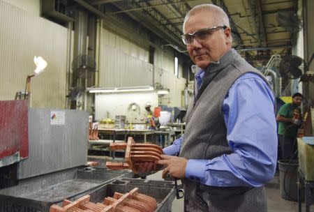 Bob Roth, CEO of transformer manufacturer RoMan Manufacturing holds a secondary coil for a transformer on the floor of his factory in Grand Rapids, Michigan, U.S., December7, 2016. REUTERS/Nick Carey