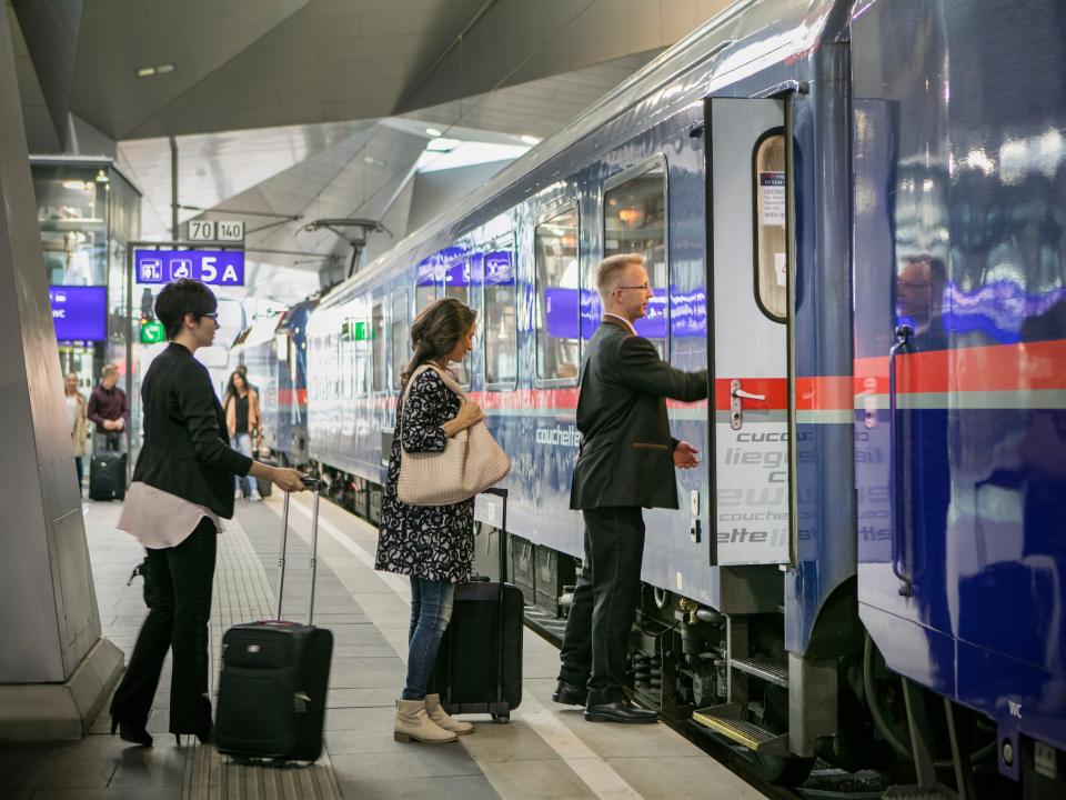 People board an OBB NIghtjet train.