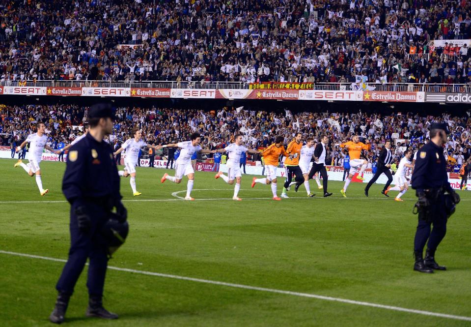 Real Madrid players run celebrating at the end of the final of the Copa del Rey between FC Barcelona and Real Madrid at the Mestalla stadium in Valencia, Spain, Wednesday, April 16, 2014. Real defeated Barcelona 2-1. (AP Photo/Manu Fernandez)