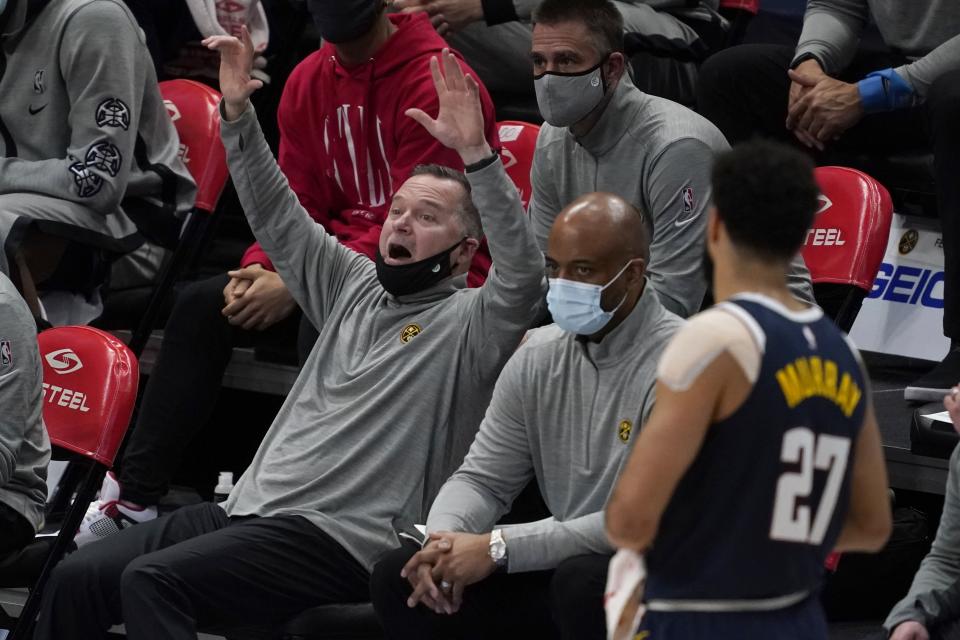 Denver Nuggets head coach Michael Malone instructs the team as guard Jamal Murray (27) looks on in the second half of an NBA basketball game against the Dallas Mavericks in Dallas, Monday, Jan. 25, 2021. (AP Photo/Tony Gutierrez)