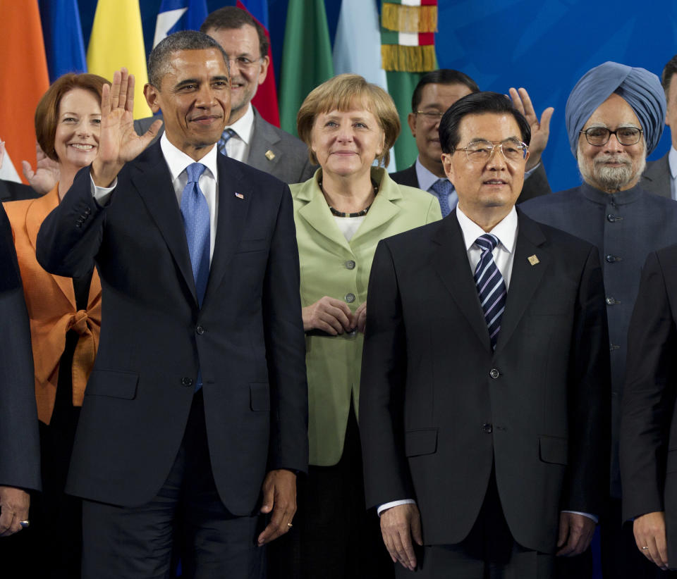 FILE - In this June 18, 2012 file photo, Chinese President Hu Jintao, right, and U.S. President Barack Obama, left, take their places with other leaders for the Family Photo during the G20 Summit in Los Cabos, Mexico. As Hu steps down as head of China’s Communist Party after 10 years in power, he’s hearing something unusual for a Chinese leader: sharp criticism. (AP Photo/Carolyn Kaster, File)