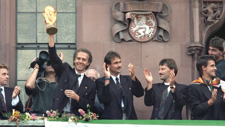 Beckenbauer celebrates with the World Cup trophy once again, this time as West Germany coach. - Kai-Uwe Wärner/picture alliance/Getty Images