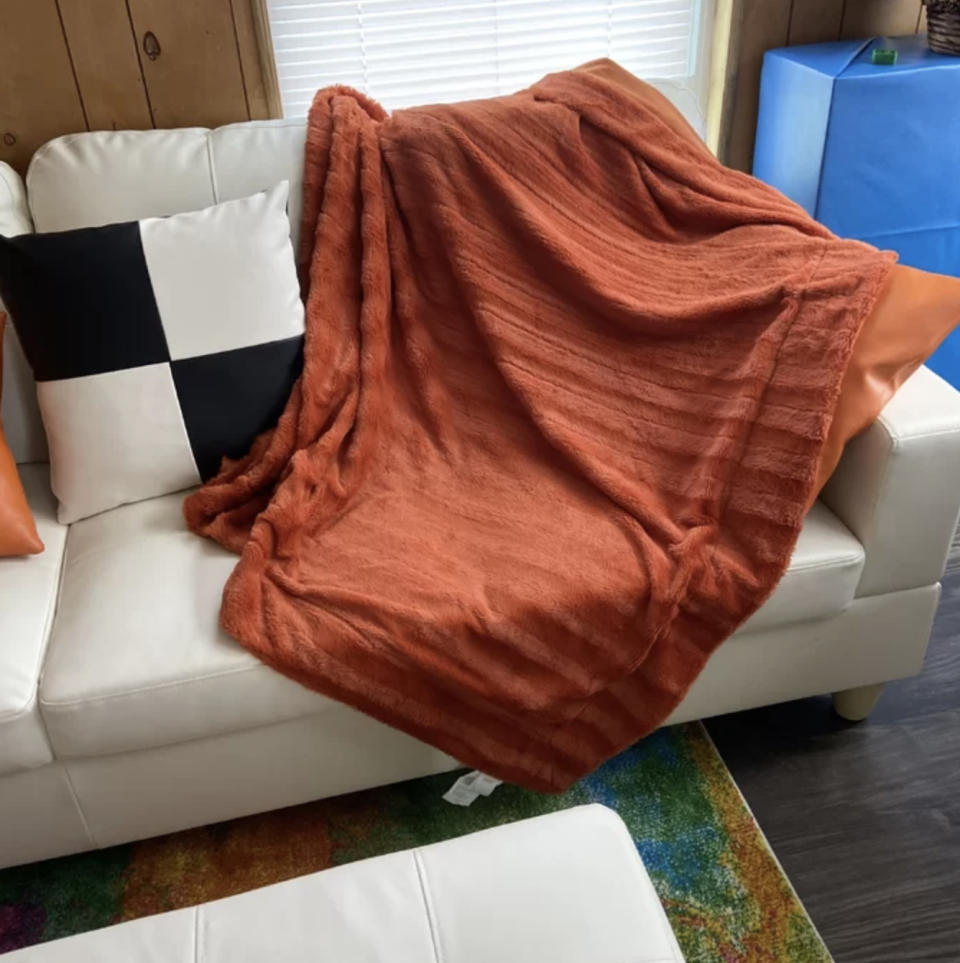 A reviewer's orange faux fur blanket