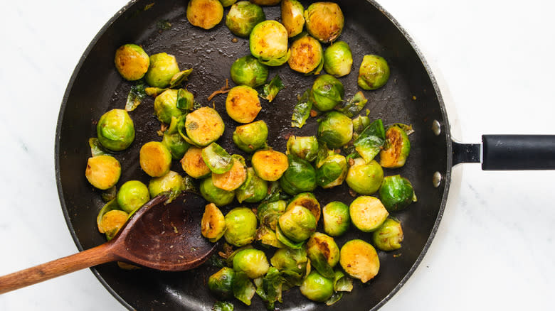 Brussels sprouts frying in pan