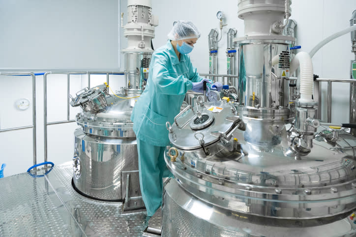 A technician in a pharmaceutical manufacturing facility.