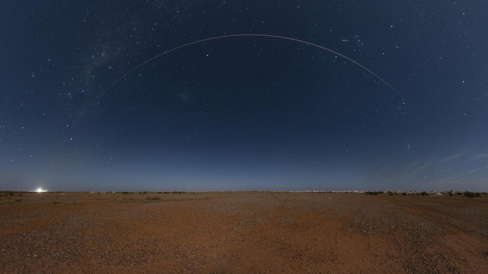 This photo provided by Japan Aerospace Exploration Agency (JAXA) shows the Japanese space capsule about to re-enter Earth with asteroid samples seen in Coober Pedy, southern Australia, on Sunday, Dec. 6, 2020. A Japanese capsule carrying the first samples of asteroid subsurface shot across the night atmosphere early Sunday before successfully landing in the remote Australian Outback, completing a mission to provide clues to the origin of the solar system and life on Earth. (JAXA via AP)