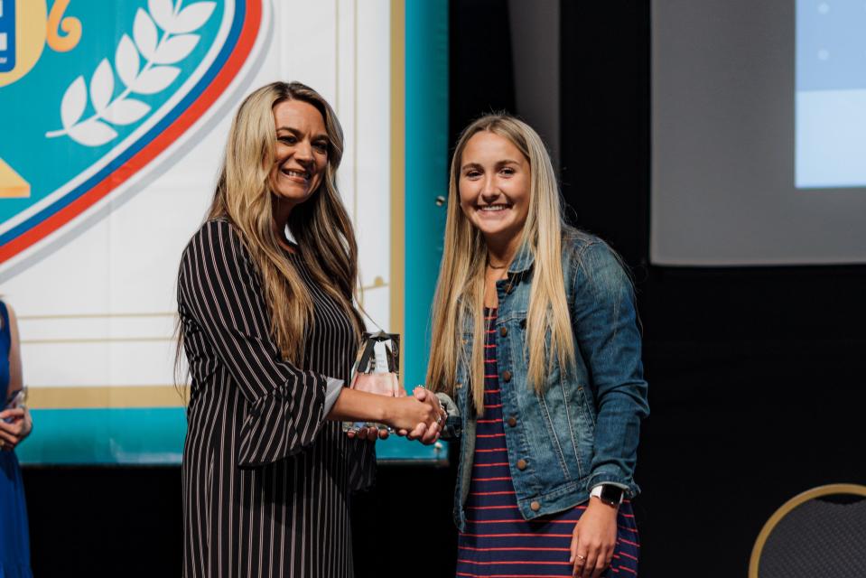 Jennifer Butler awards Maddie Shelly with the 2022 Female Athlete of the Year during the Night of Scholars and Champions held at the Bartlesville Community Center Monday evening.