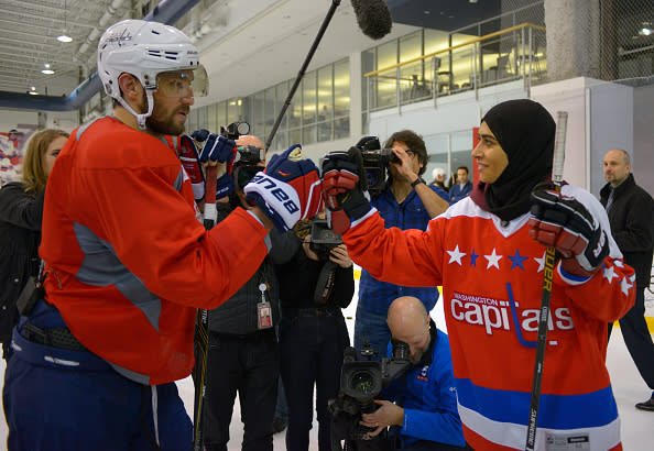 ARLINGTON VA, FEBRUARY 8: United Arab Emirates native Fatima Al Ali, right, bumps gloves with Capitals Alex Ovechkin after practice. She's a young female hockey player who showed incredible stick handling skills at a clinic in UAE, which went viral.The Washington Capitals hosted Al Ali to mix with the team near the end of practice at the Capitals practice facility in Arlington VA, February 8, 2017. (Photo by John McDonnell / The Washington Post via Getty Images)