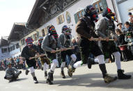 <p>So-called “Pfannenzieher” (pan pullers) carnival characters parade through the streets of Mittenwald, southern Germany, as the hot carnival season starts on Women’s Carnival, Feb. 23, 2017. (Photo: Angelika Warmuth/AFP/Getty Images) </p>