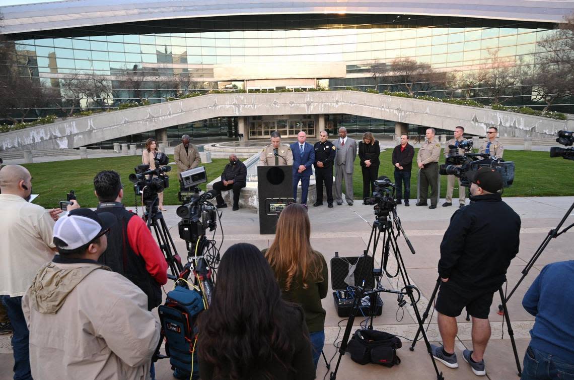 Fresno County Sheriff John Zanoni, at lectern, is seen with a dozen others at a press conference outside Fresno City Hall addressing Memphis police video being released Friday Jan. 27, 2023.
