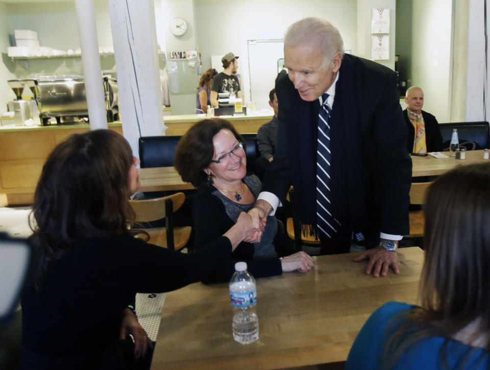 Vice President Joe Biden greets women who have either signed up for coverage or have helped others sign up for insurance under the federal health care law during a stop at Moose and Sadie's coffee shop Wednesday, Feb. 19, 2014, in Minneapolis. (AP Photo/Jim Mone,Pool)