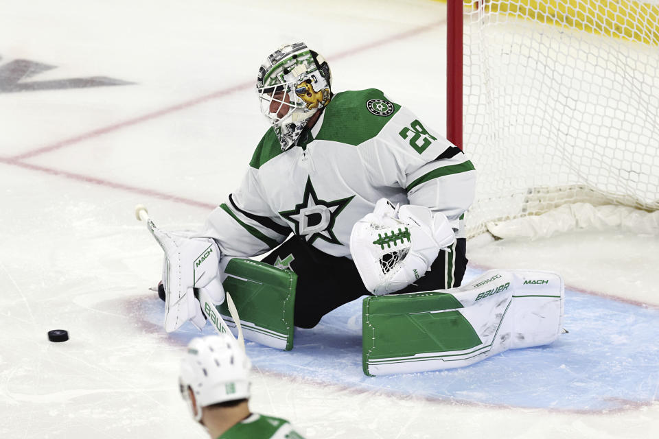 Dallas Stars goaltender Jake Oettinger stops the puck during the first period against the Minnesota Wild in Game 3 of an NHL hockey Stanley Cup first-round playoff series Friday, April 21, 2023, in St. Paul, Minn. (AP Photo/Stacy Bengs)