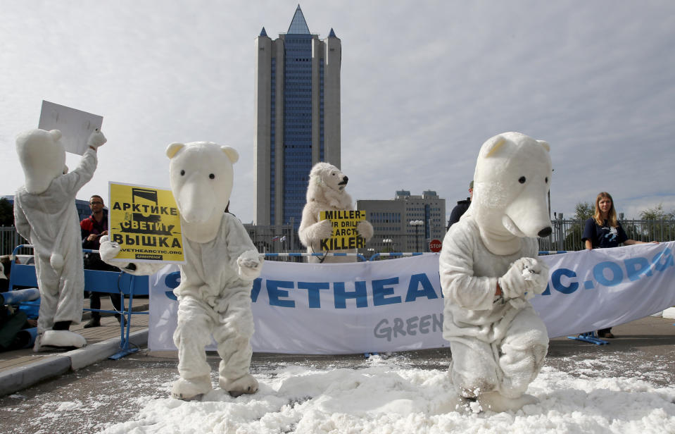 Greenpeace activists dressed as polar bears protest outside Gazprom's headquarters in Moscow, Russia, Wednesday, Sept. 5, 2012. Russian and international environmentalists are protesting against Gazprom's plans to pioneer oil drilling in the Arctic. (AP Photo/Misha Japaridze)