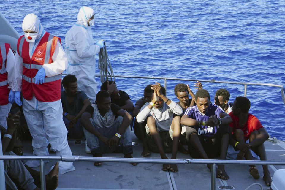 Migrants are evacuated by Italian Coast guards from the Open Arms Spanish humanitarian boat at the coasts of the Sicilian island of Lampedusa, southern Italy, Saturday, Aug. 17, 2019. Italy’s hard-line interior minister buckled under pressure Saturday and agreed to let 27 unaccompanied minors leave a migrant rescue ship after two weeks at sea, temporarily easing a political standoff that has threatened the viability of the populist government. (AP Photo/Francisco Gentico)