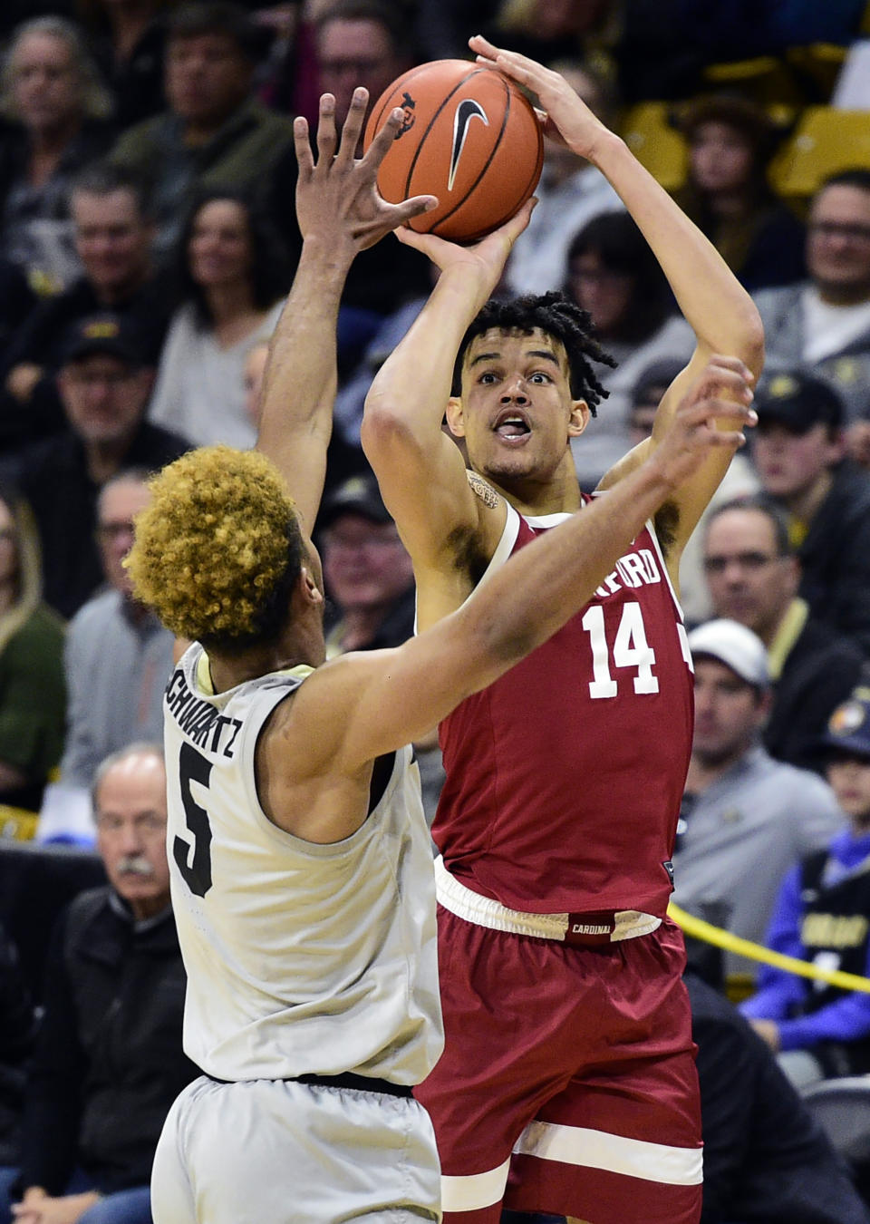 Stanford's Spencer Jones shoots over Colorado's D'Shawn Schwartz during the first half of an NCAA college basketball game Saturday, Feb. 8, 2020, in Boulder, Colo. (AP Photo/ Cliff Grassmick)