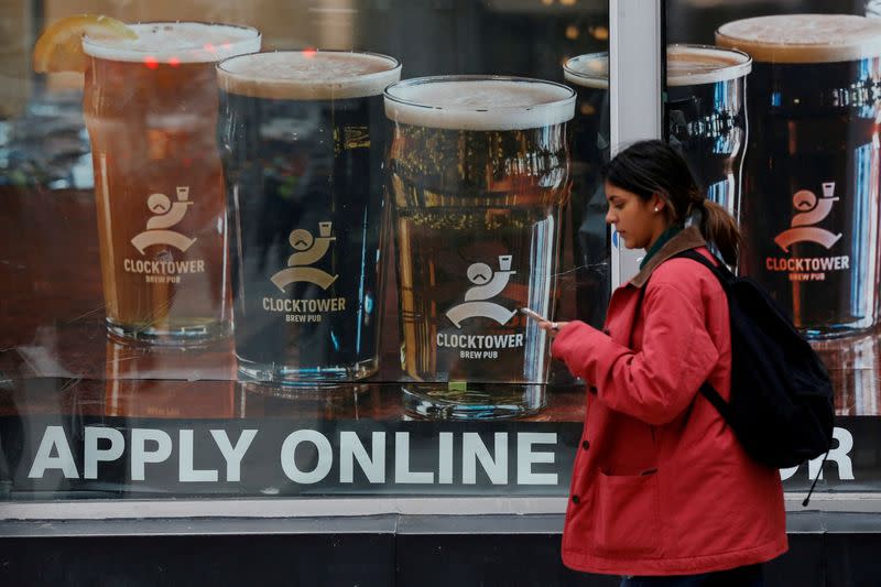 FILE PHOTO: FILE PHOTO: A sign advertising available jobs at the Clocktower Brew Pub hangs in a window in Ottawa