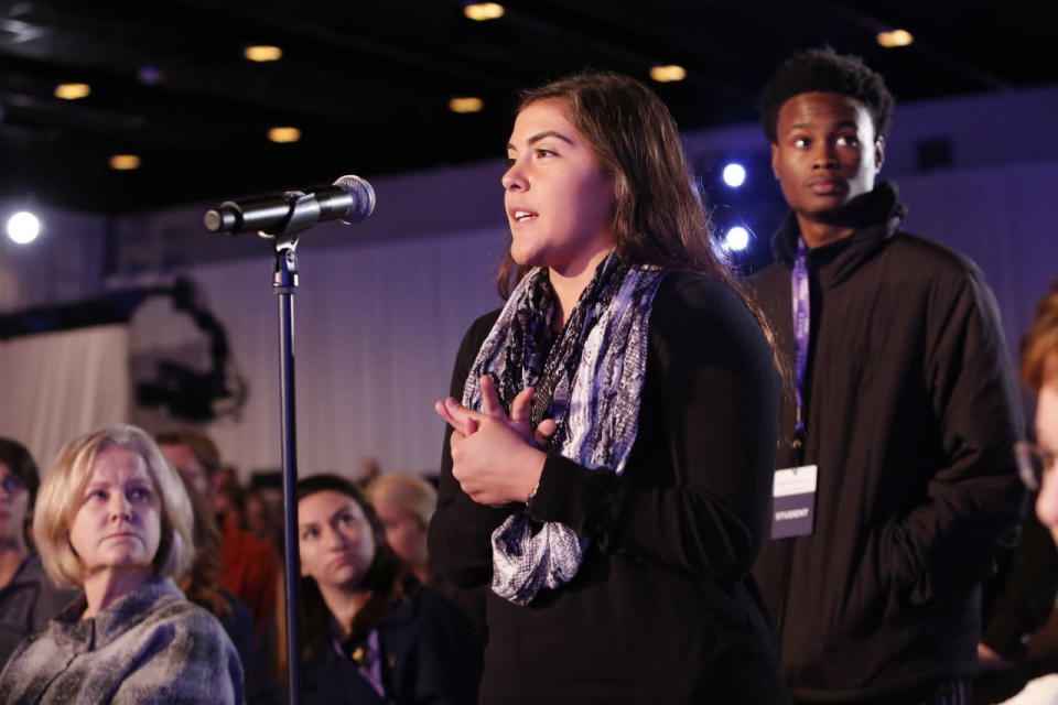 A student poses a question to the panel.