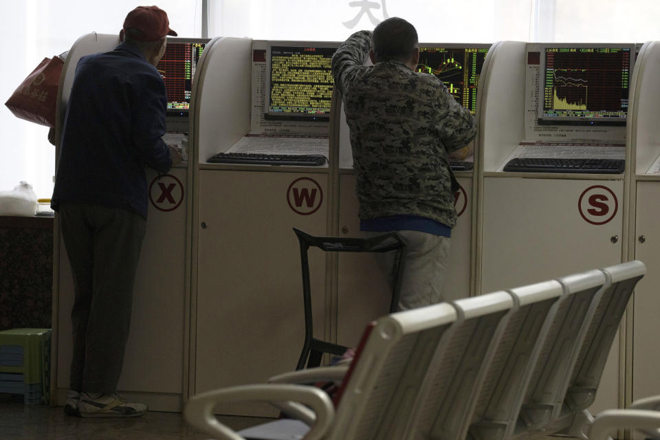 Investors monitor terminals at a brokerage in Beijing Monday, Nov. 11, 2019. Shares declined Monday in Asia as investors watched for the latest developments in the China-U.S. trade war sage. (AP Photo/Ng Han Guan)