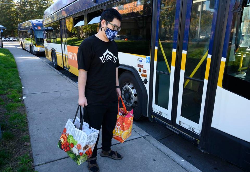 Jordan Wang carries groceries after shopping at a nearby grocery store, a bus ride away from his Pocket area apartment on Friday, Nov. 19. Aspiranet is asking Book of Dreams readers for donations to purchase 80 foldable metal grocery carts for their clients who don’t have cars.