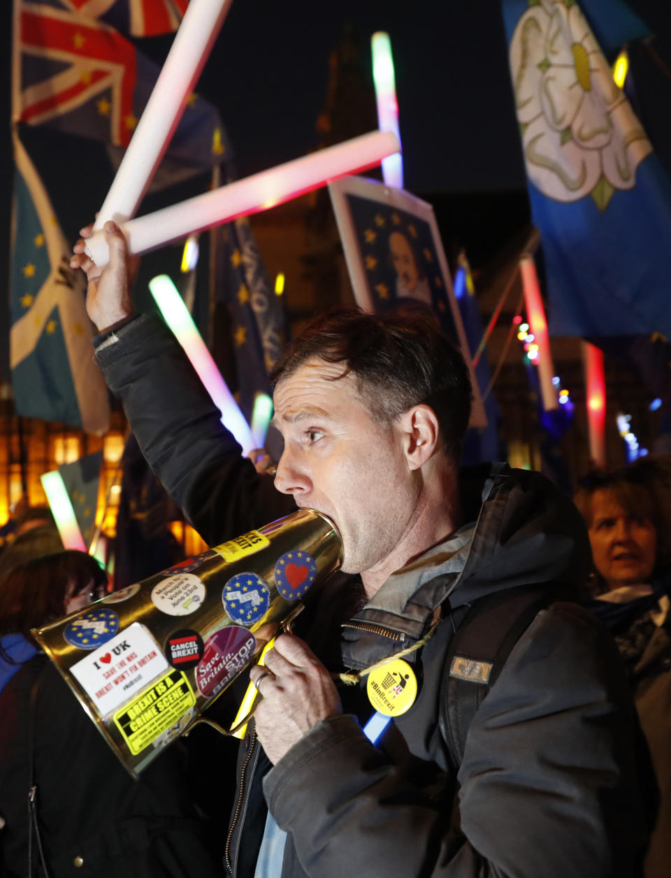 Remain in the European Union demonstrators use a megaphone outside the Palace of Westminster in London, Wednesday, Feb. 27, 2019. British Prime Minister Theresa May says she will give British lawmakers a choice of approving her divorce agreement, leaving the EU March 29 without a deal or asking to delay Brexit by up to three months. (AP Photo/Alastair Grant)