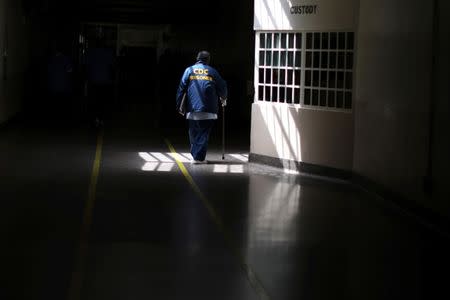 A prisoner walks with the aid of a stick at the California Medical Facility prison in Vacaville, California, U.S., May 23, 2018. REUTERS/Lucy Nicholson