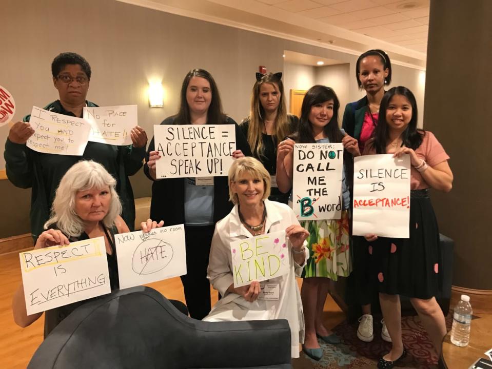 <div class="inline-image__caption"><p>A dozen NOW members descended on a happy hour at the 2017 conference with signs protesting racism in the organization.</p></div> <div class="inline-image__credit">Courtesy Julie Tran Deilly</div>