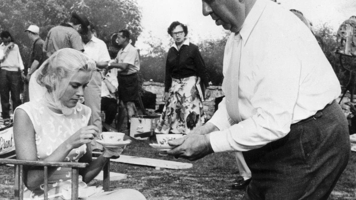 Grace Kelly and Alfred Hitchcock having tea, 1955.