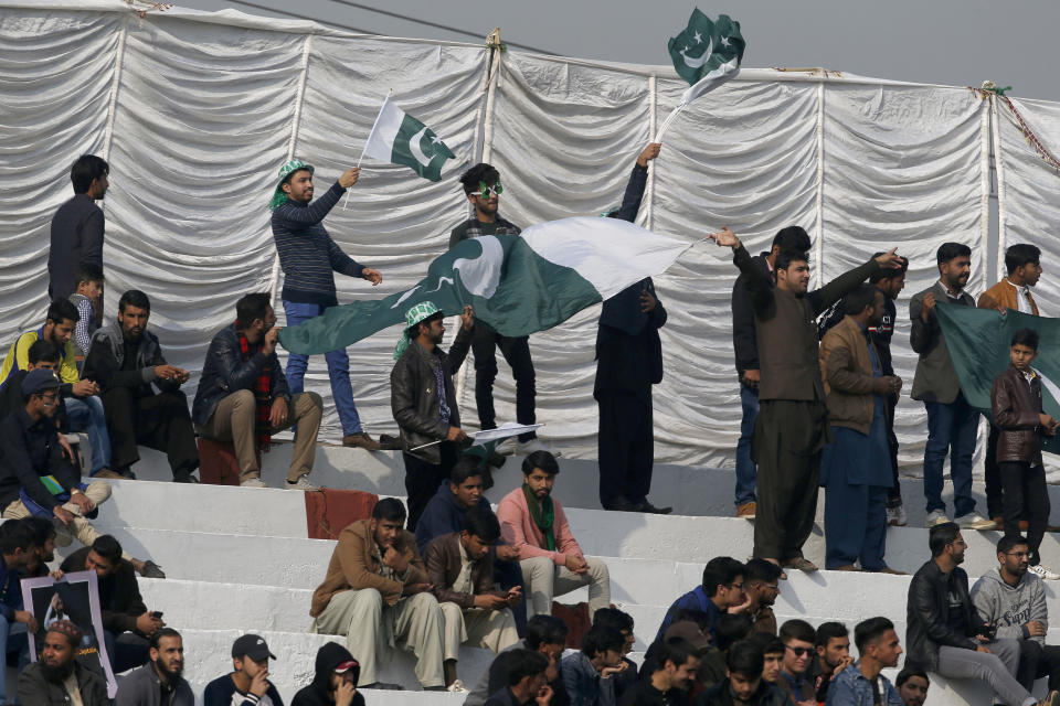Cricket fans cheer during the first-day of the 1st cricket test match between Pakistan and Sri Lanka, in Rawalpindi, Pakistan, Wednesday, Dec. 11, 2019. (AP Photo/Anjum Naveed)