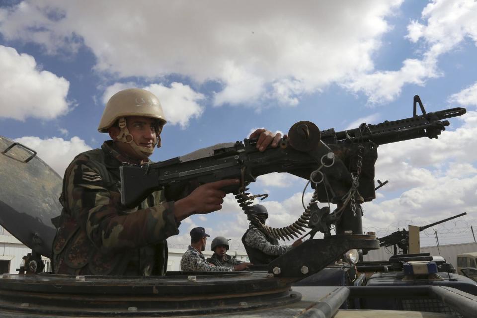 In this picture taken Tuesday, Feb. 14, 2017, a Jordanian soldier stands at the north eastern border with Syria, close to the informal Rukban camp. The commander of Jordan's border guards says Islamic State extremists are expanding their influence in the sprawling border camp for tens of thousands of displaced Syrians, posing a growing threat to the U.S.-allied kingdom. (AP Photo/ Raad Adayleh)