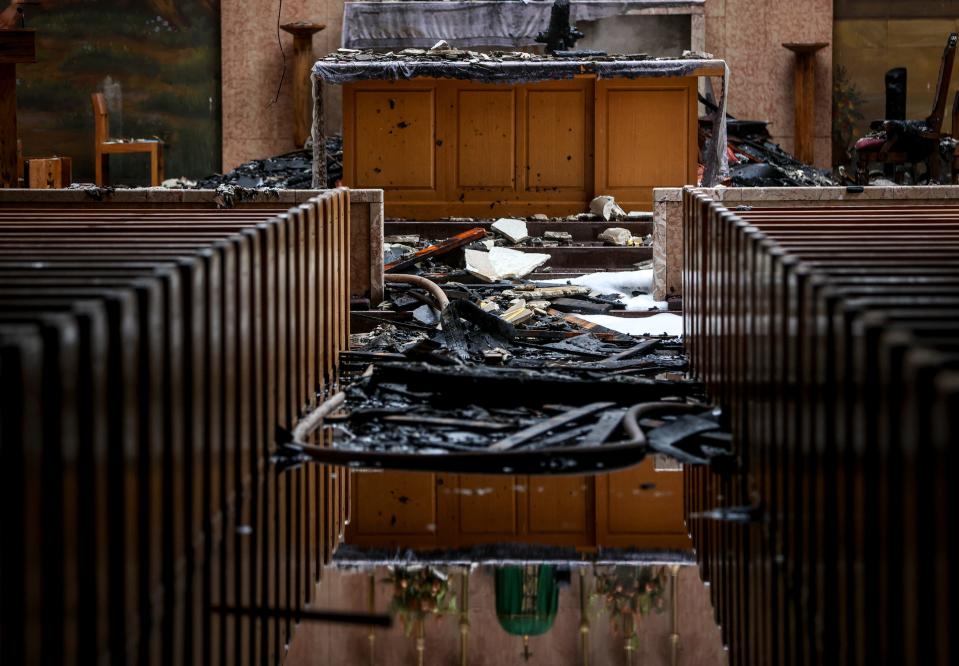 Several inches of standing water and debris fill the floors of the church after a structure fire at St. Joseph's Catholic Church on Thursday.