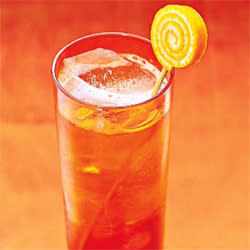 What to serve: Liven up usually clear cocktails with flavored liquor, like a Van Gogh Oranje Vodka and soda.