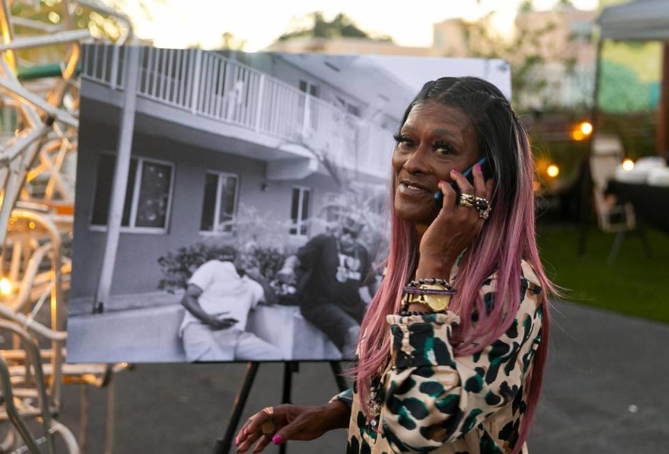 Elaine Williams, 65, stands next to her photo that is for sale during The Smile Trust’s “Smile Fuh Me” event at the N’Namdi Contemporary Fine Art Gallery in Miami’s Little Haiti neighborhood on Sunday, Dec. 5, 2021.