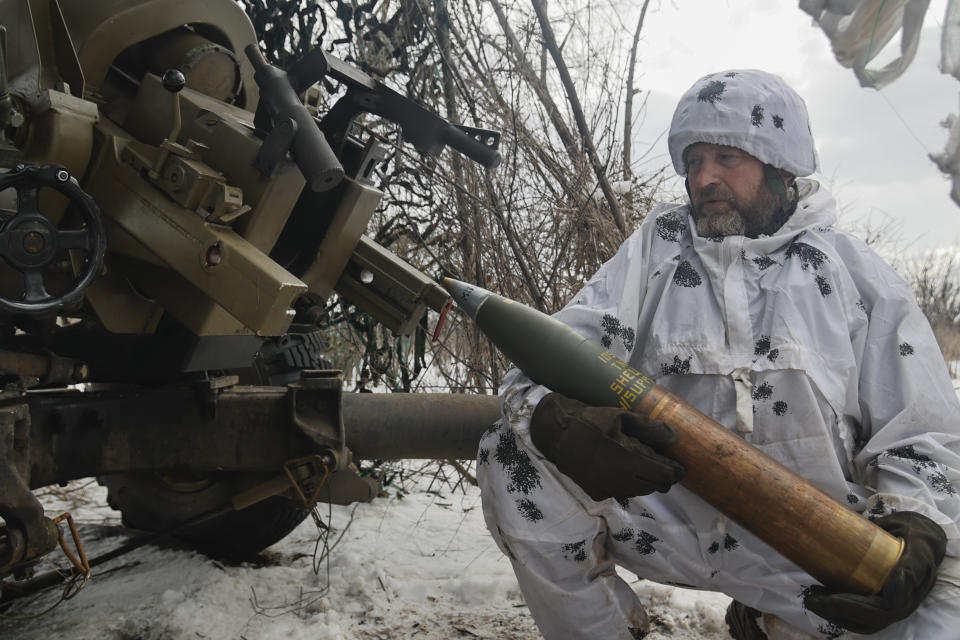 A Ukrainian soldier prepares to fire an artillery at Russian positions near Bakhmut, Donetsk region, Ukraine, Wednesday, Feb. 15, 2023. (AP Photo/Roman Chop)