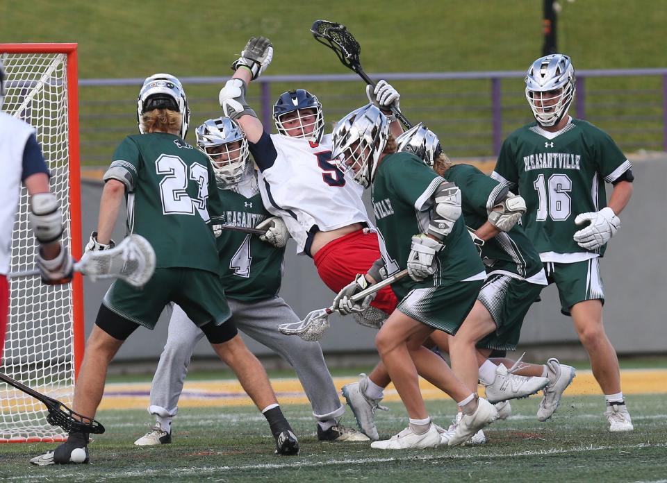 Pleasantville defenders try to keep Cold Spring Harbor's Reagan Reilly (5) from the goal during the boys lacrosse state Class D semifinal at Ford Field on the campus of the University at Albany June 9, 2023.