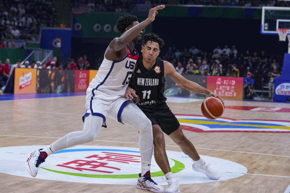 New Zealand guard Flynn Cameron (11) drives on U.S. forward Jaren Jackson Jr. (13) during the first half of a Basketball World Cup group C match in Manila, Saturday, Aug. 26, 2023. (AP Photo/Michael Conroy)