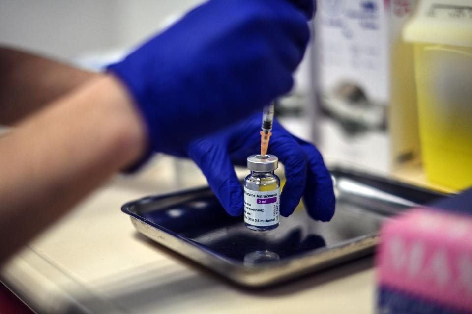 <p>A nurse prepares a dose of the Oxford vaccine</p> (Getty )