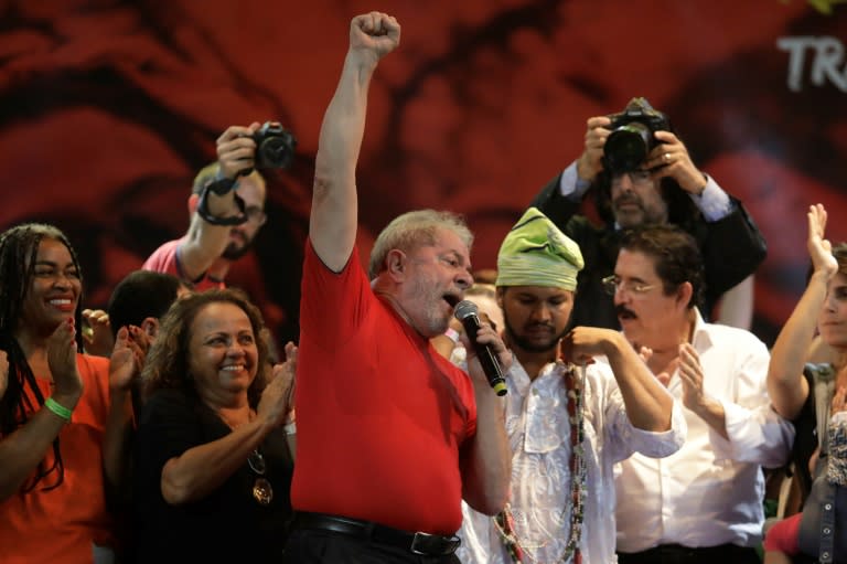 Brazilian former president Luiz Inacio Lula da Silva (C), shown here in March 2018, has near double the support of all other main candidates in a first round of voting, polls show -- even though he's behind bars