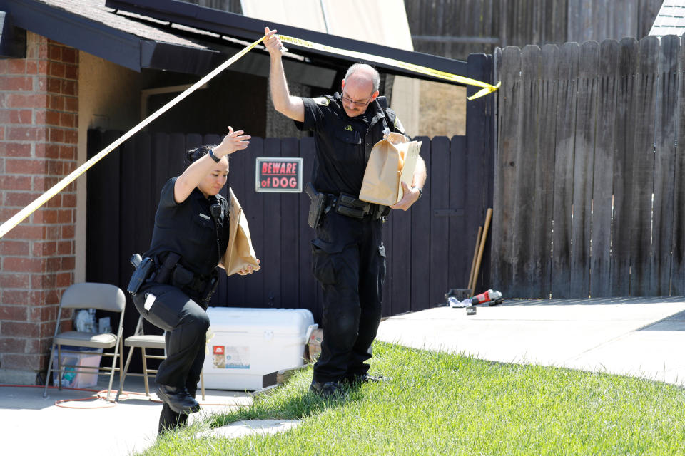 Investigators remove items in evidence bags from the home of Joseph James DeAngelo, who is now charged in 12 previously unsolved homicides. (Photo: Fred Greaves/Reuters)