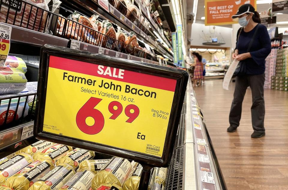 A person shops in the meat section of a grocery store in 2021, in Los Angeles.