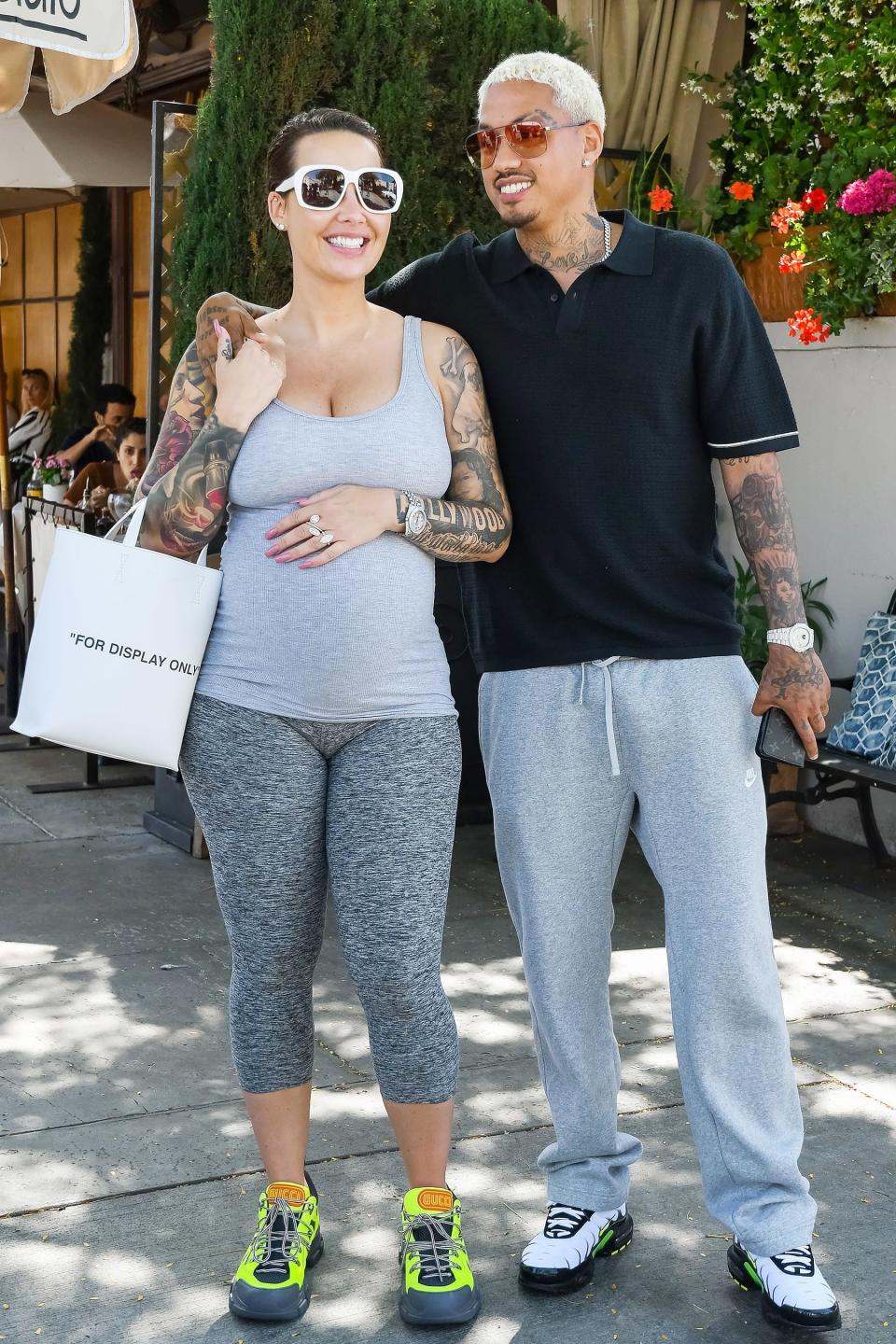 Expecting parents Amber Rose and Alexander Edwards enjoy a walk out in L.A. on Thursday.