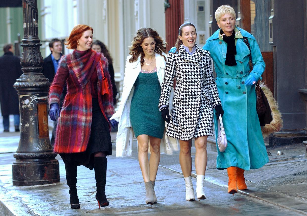 UNITED STATES - FEBRUARY 02:  Cynthia Nixon, Sarah Jessica Parker, Kristin Davis and Kim Cattrall (l. to r.) walk along Greene St. during filming of a scene for the last episode of 