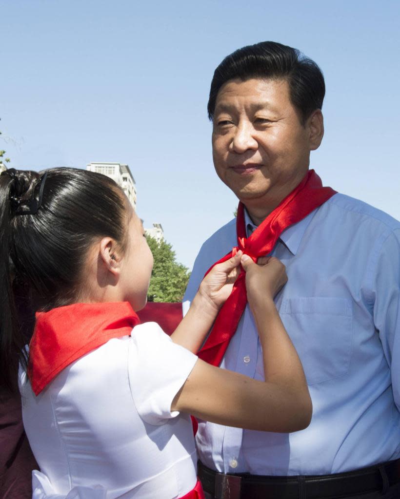 China’s leader Xi Jinping sports a red scarf in honor of the CCP. Alamy Stock Photo