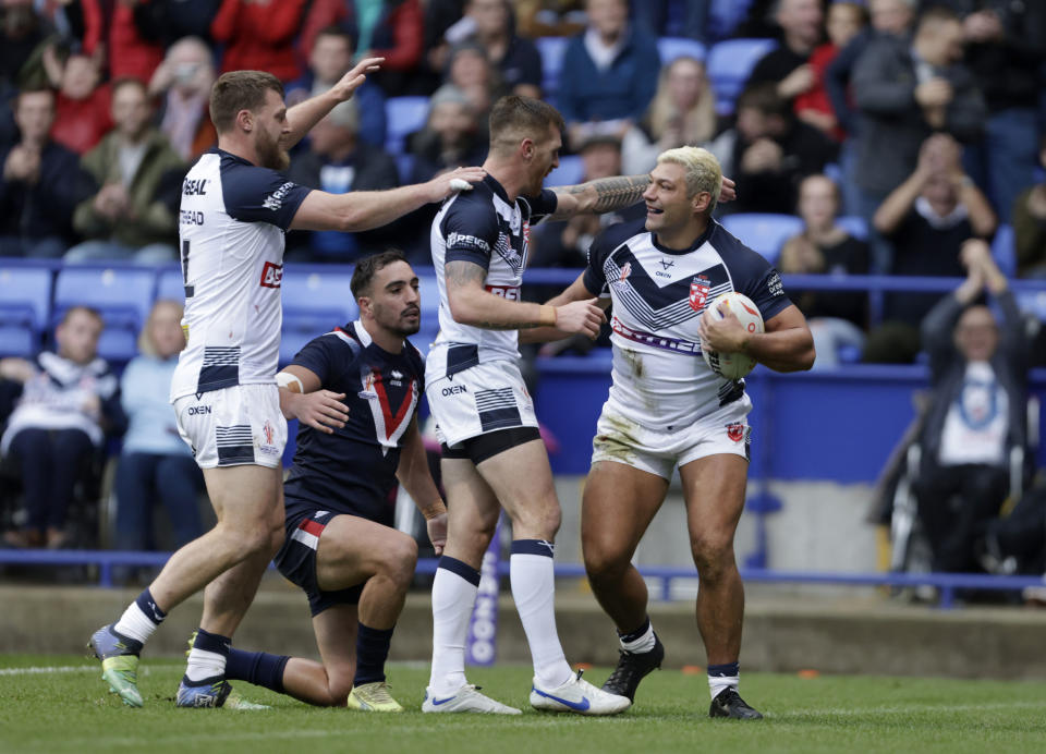 England's Ryan Hall, right, celebrates scoring during the Rugby League World Cup group A match between England and France at the University of Bolton Stadium, Bolton, England, Saturday Oct. 22, 2022. (Richard Sellers/PA via AP)