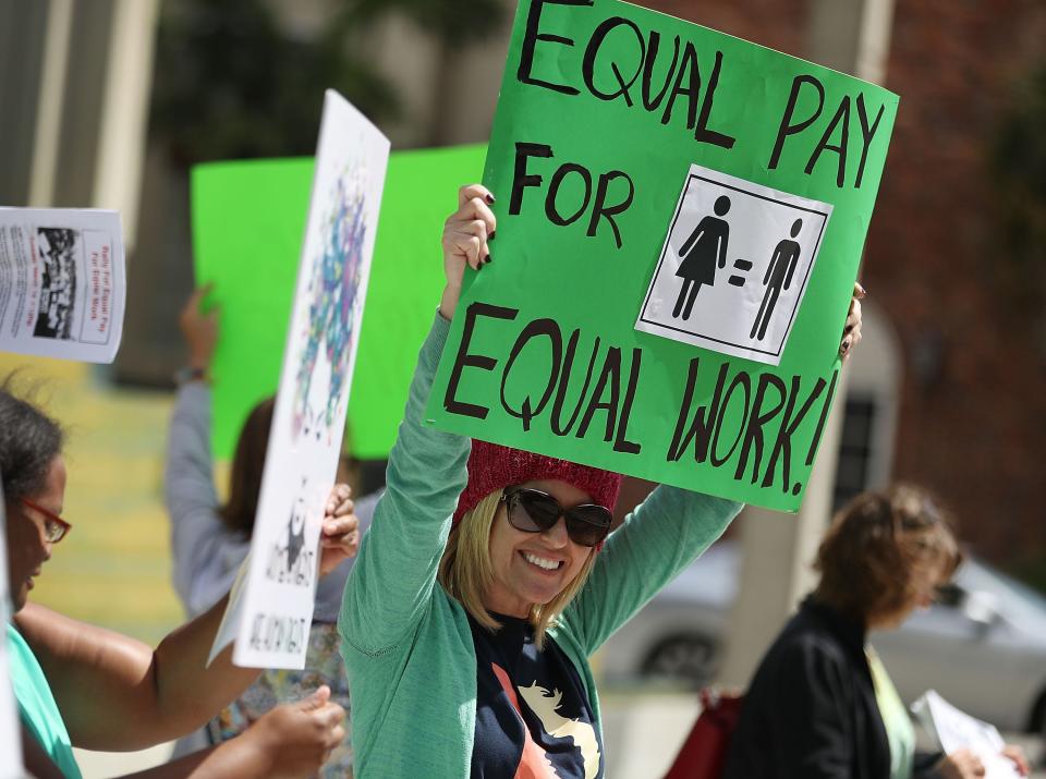Elana Goodman joins with other protesters to ask that woman be given the chance to have equal pay as their male co-workers in 2017 in Fort Lauderdale, Florida.
