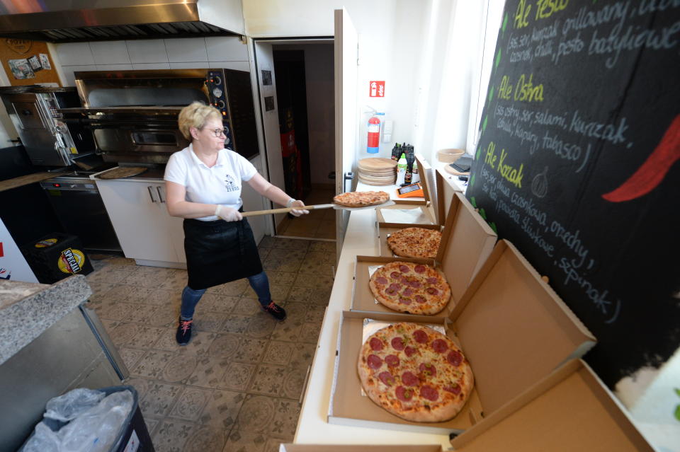 In this photo taken March 18, 2020, Bozena Legowska is making free pizzas for the doctors and medics of the Bielany hospital in Warsaw, Poland, as part of a nationwide action in a gesture of support for their unstopping fight against the spreading coronavirus. Restaurants and eateries remain closed to the public under a "national quarantine" aimed at breaking the human transmission belt for the virus, but they can do deliveries. (AP Photo/Czarek Sokolowski)