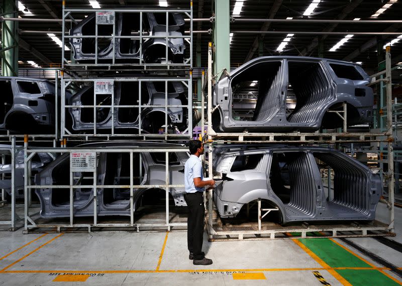 FILE PHOTO: An employee works inside the Mahindra & Mahindra manufacturing plant in Chakan