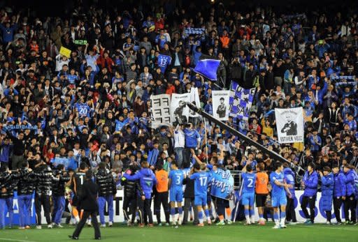 Ulsan Hyundai celebrate with their supporters after winning the AFC Champions League final against Saudi Arabia's Al Ahli 3-0. Victory, thanks to goals from Kwak Tae-Hwi, Rafinha and Kim Seung-Yong, ensured Ulsan went through the entire tournament unbeaten