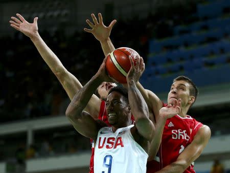 Demar Derozan of the USA, Nikola Kalinic and Bogdan Bogdanovic of Serbia in action. REUTERS/Marko Djurica