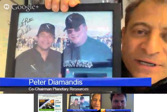 Peter Diamandis displays an autographed photo of himself with William Shatner, during an online videochat, June 25, 2013.